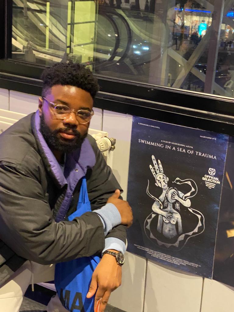 Ugo Azuya posing with his film's poster
